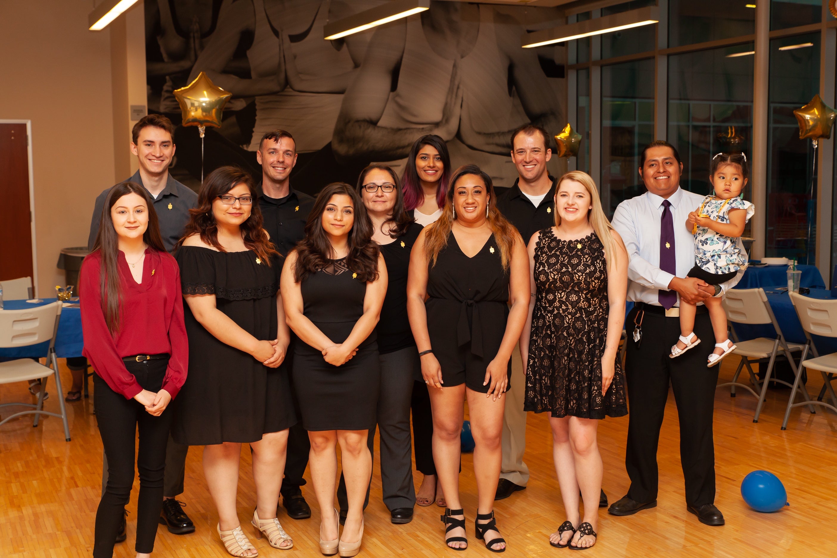 students in formal attire smiling for picture