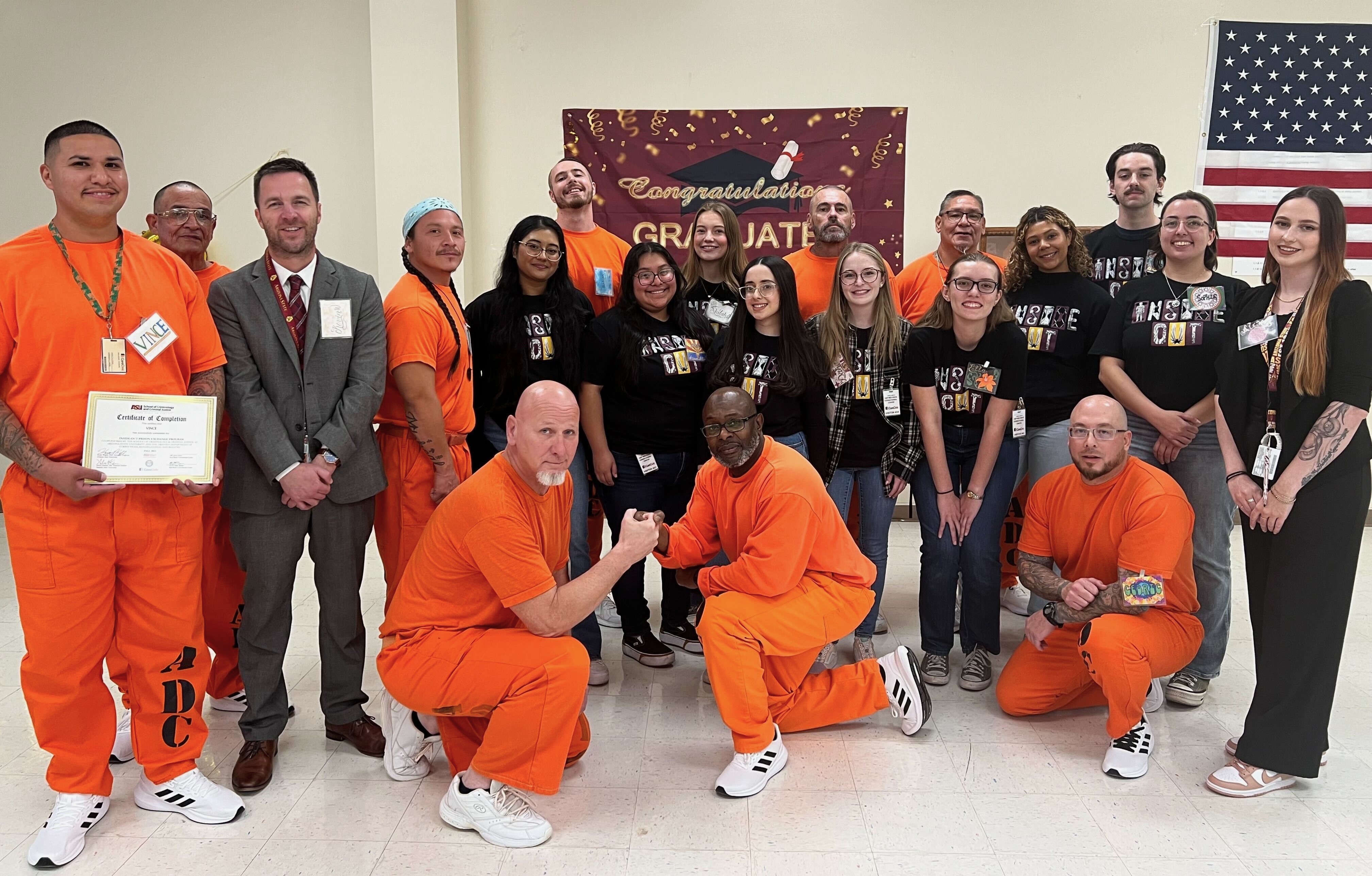 Inside-Out Class of Fall 2023; people standing together, half dressed in orange and the other half with black t-shirts