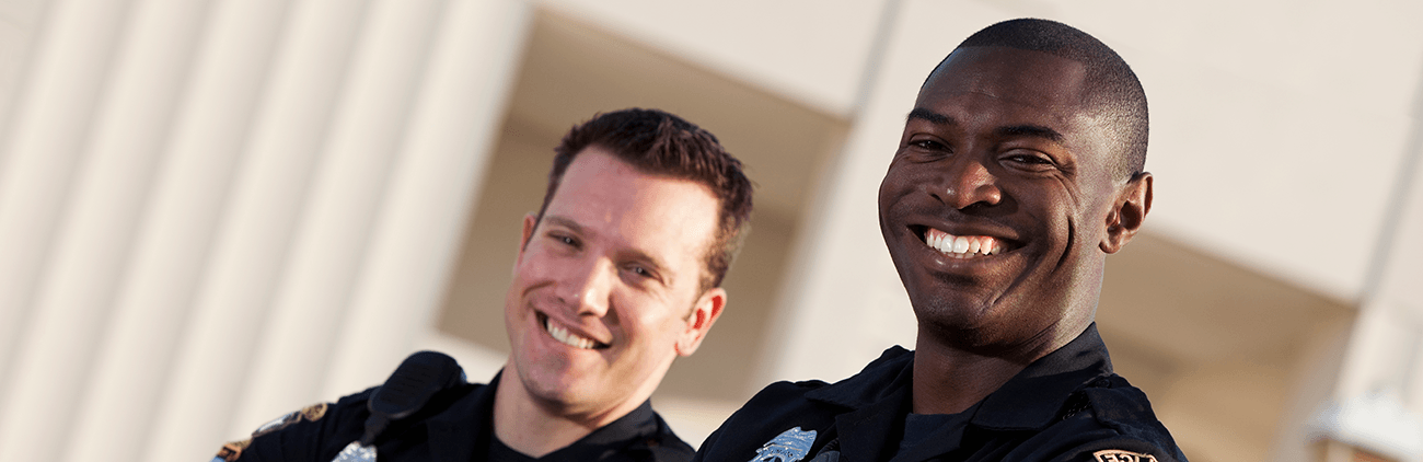 two male police officers smiling