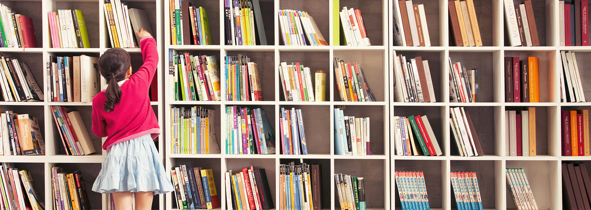 Children in the Law (CITL) Laboratory - young girl reaching for a book on a bookshelf